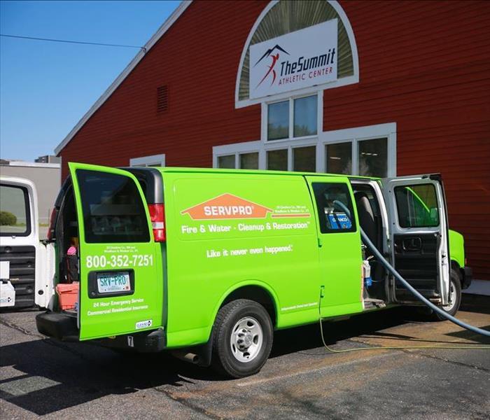 A SERVPRO van outside of a building